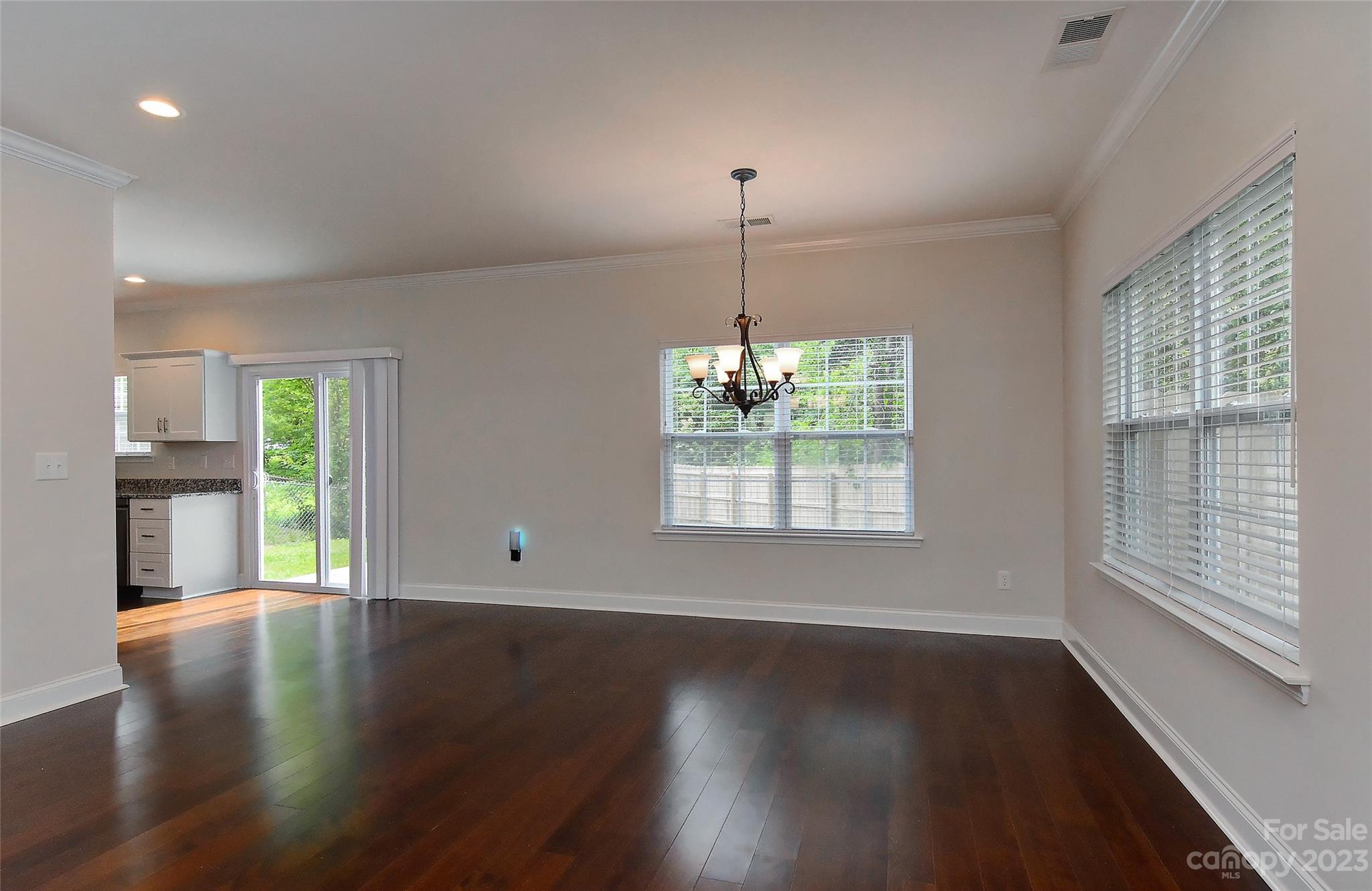 6413 McBride Street Charlotte, NC 28215 - Photo 4 of 21 a view of an empty room with wooden floor and a window