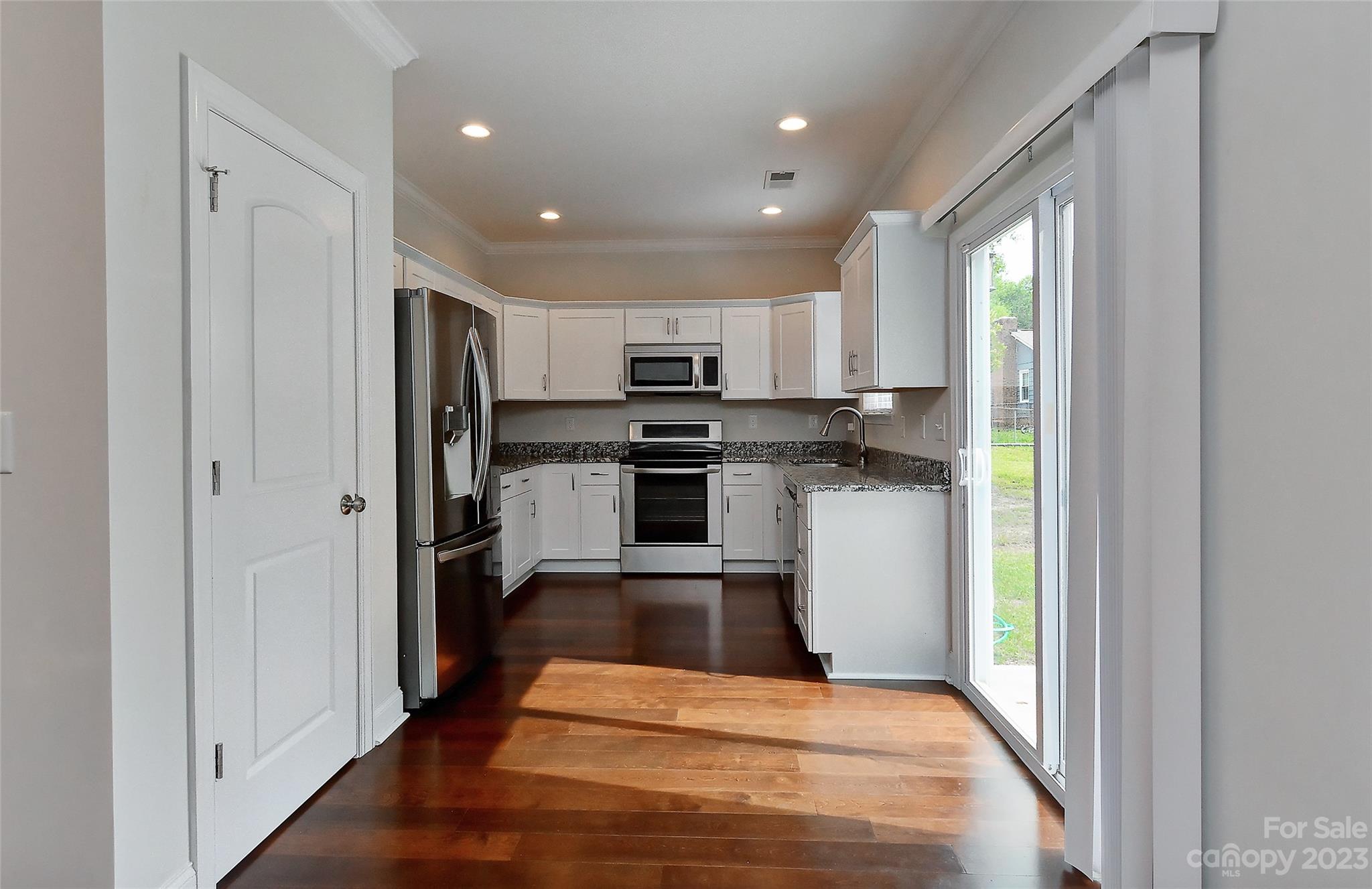 6413 McBride Street Charlotte, NC 28215 - Photo 6 of 21 a kitchen with stainless steel appliances granite countertop a refrigerator and a stove top oven