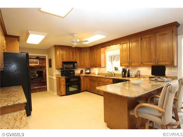 8206 Spring Meadow Road North Chesterfield, VA 23235 - Photo 12 of 24 a kitchen with a sink refrigerator and microwave