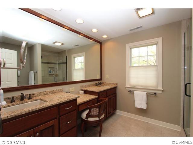 8206 Spring Meadow Road North Chesterfield, VA 23235 - Photo 19 of 24 a bathroom with a granite countertop sink a large mirror and a toilet