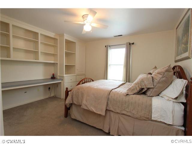 8206 Spring Meadow Road North Chesterfield, VA 23235 - Photo 21 of 24 a bedroom with a bed and a chandelier