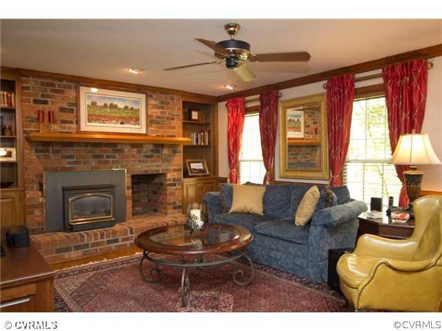 8206 Spring Meadow Road North Chesterfield, VA 23235 - Photo 8 of 24 a living room with furniture a fireplace and a large window