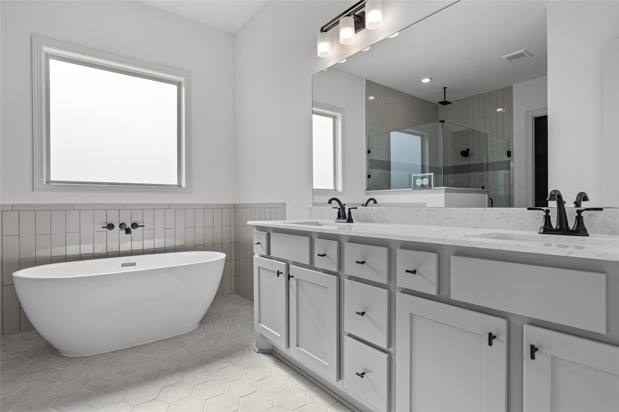 1819 Rymal Ranch Road Alvin, TX 77511 - Photo 10 of 17 a bathroom with double vanity sinks and a bathtub