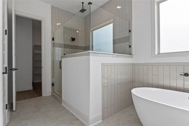 a bathroom with double vanity sinks and a bathtub