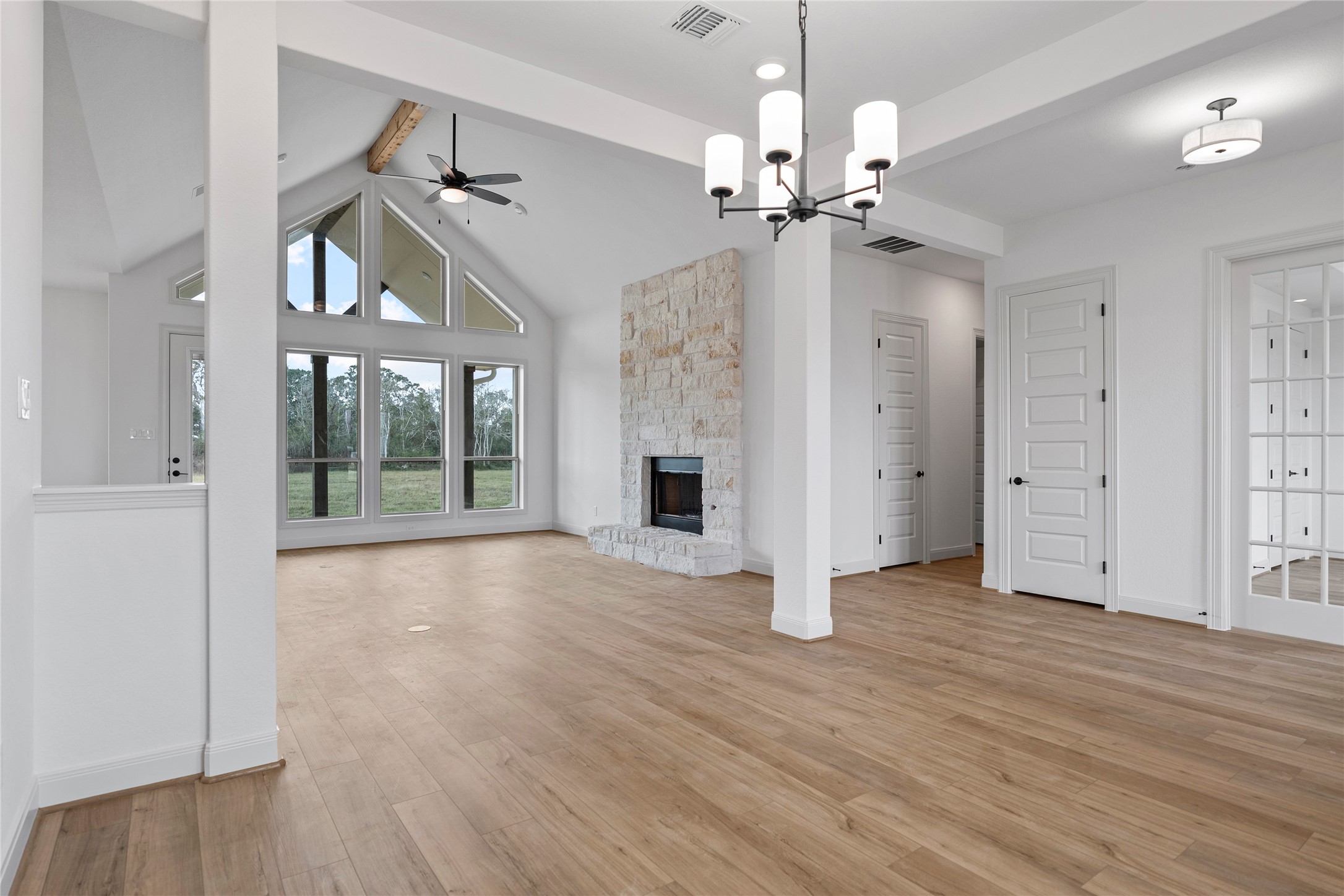 1819 Rymal Ranch Road Alvin, TX 77511 - Photo 16 of 17 a view of an empty room with wooden floor fireplace and a window
