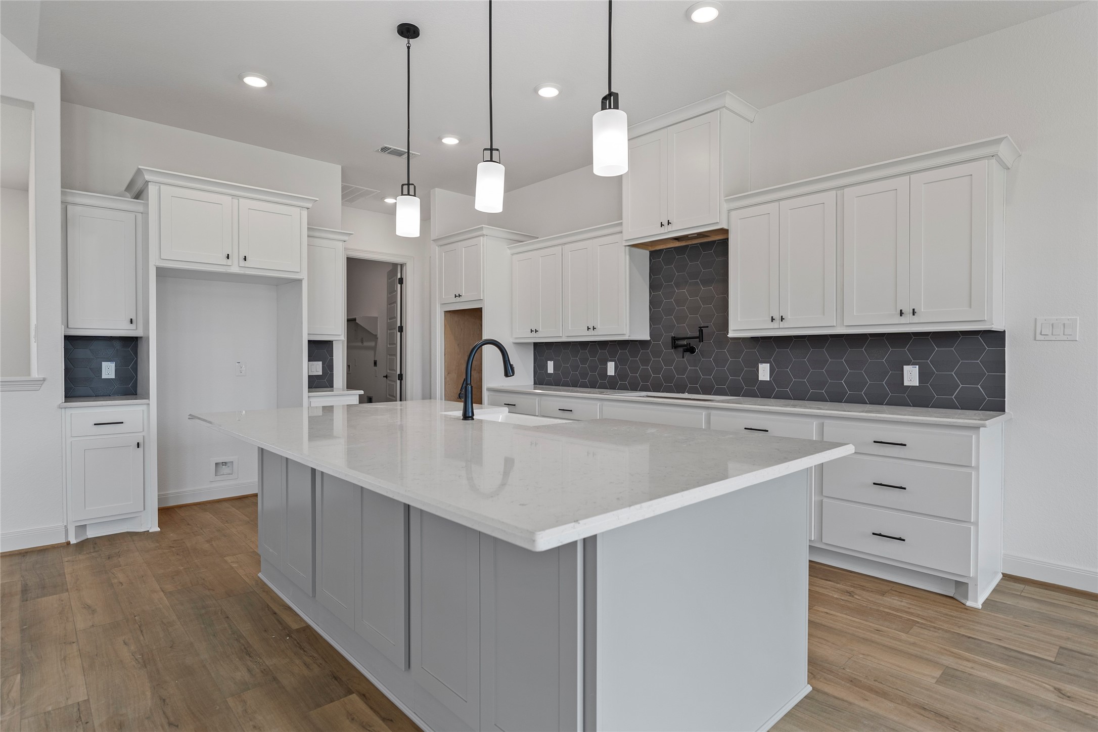 1819 Rymal Ranch Road Alvin, TX 77511 - Photo 6 of 17 a kitchen with kitchen island a sink stainless steel appliances and cabinets
