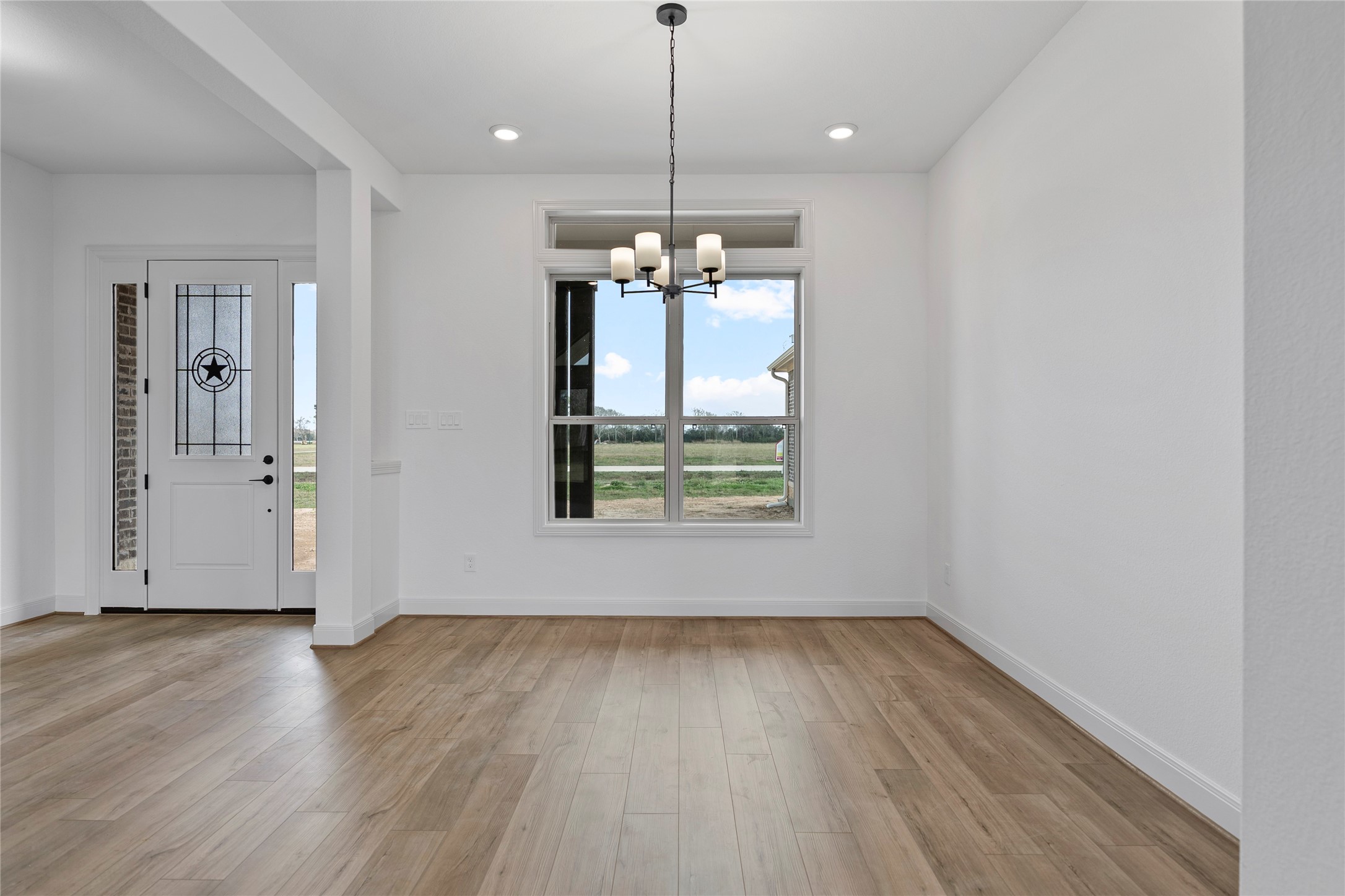 1819 Rymal Ranch Road Alvin, TX 77511 - Photo 7 of 17 a view of a room with wooden floor ceiling fan and windows