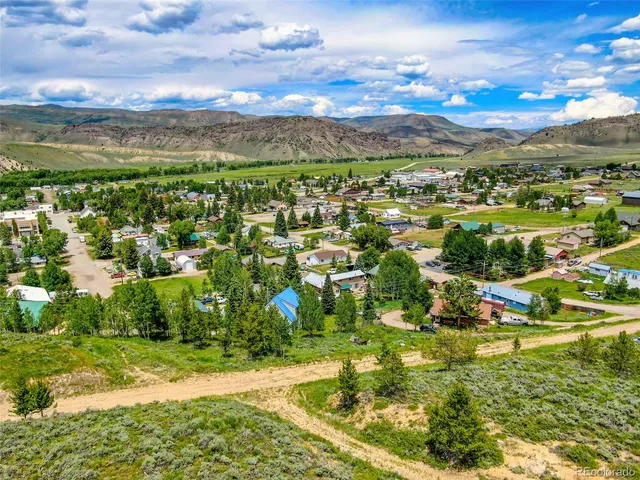 a view of a lush green hillside and houses