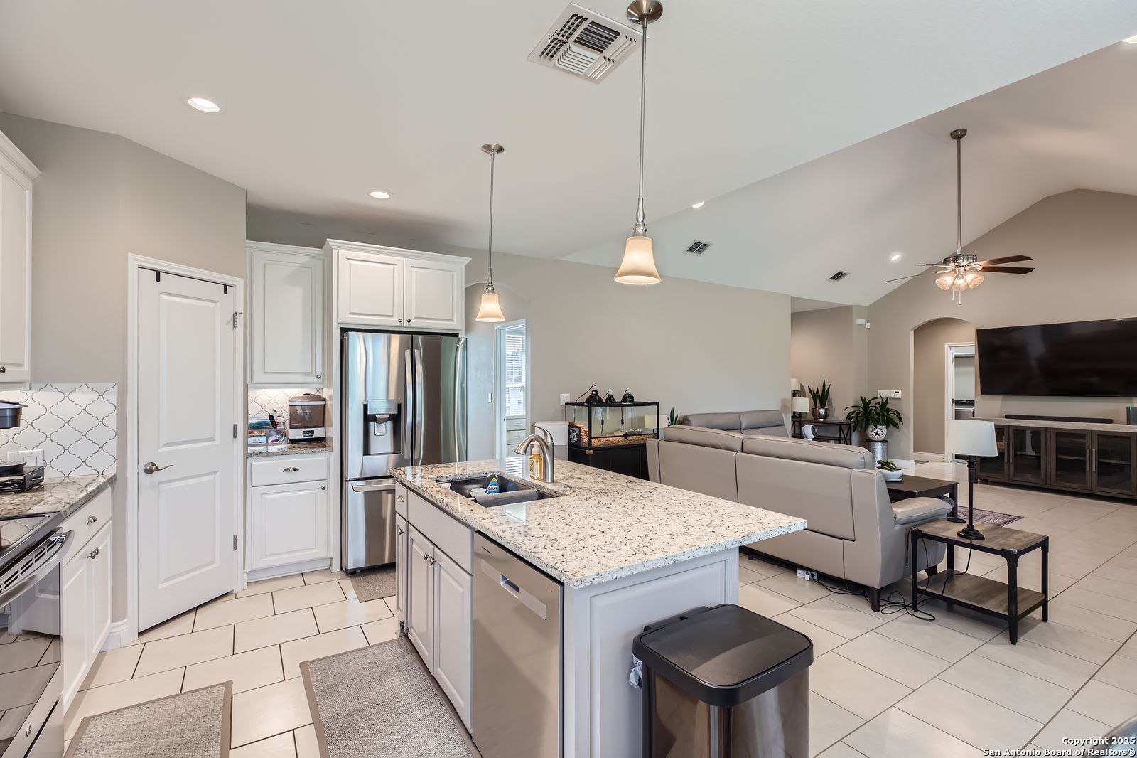 1041 Madrone Road Fischer, TX 78623 - Photo 12 of 29 a kitchen with stainless steel appliances kitchen island granite countertop a sink refrigerator and cabinets