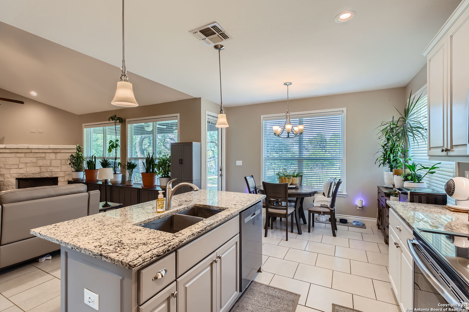 1041 Madrone Road Fischer, TX 78623 - Photo 13 of 29 a kitchen with a counter top space a sink stove and cabinets
