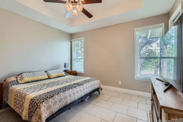 a bedroom with a large bed and a window