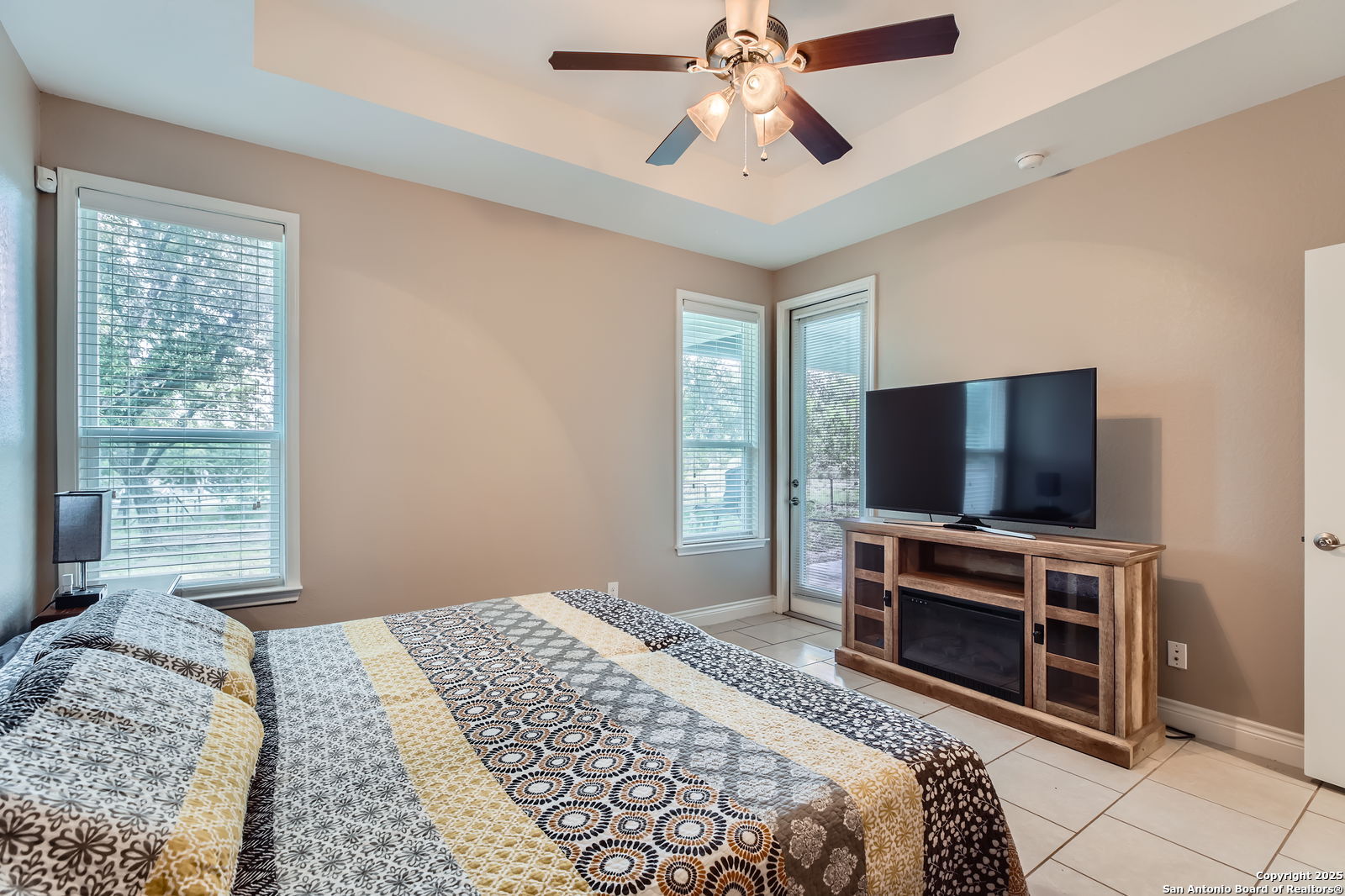 1041 Madrone Road Fischer, TX 78623 - Photo 17 of 29 a bedroom with a bed and a flat screen tv