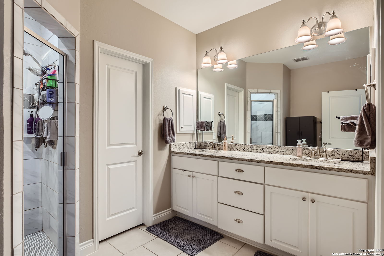 1041 Madrone Road Fischer, TX 78623 - Photo 18 of 29 a bathroom with a double vanity sink and a mirror