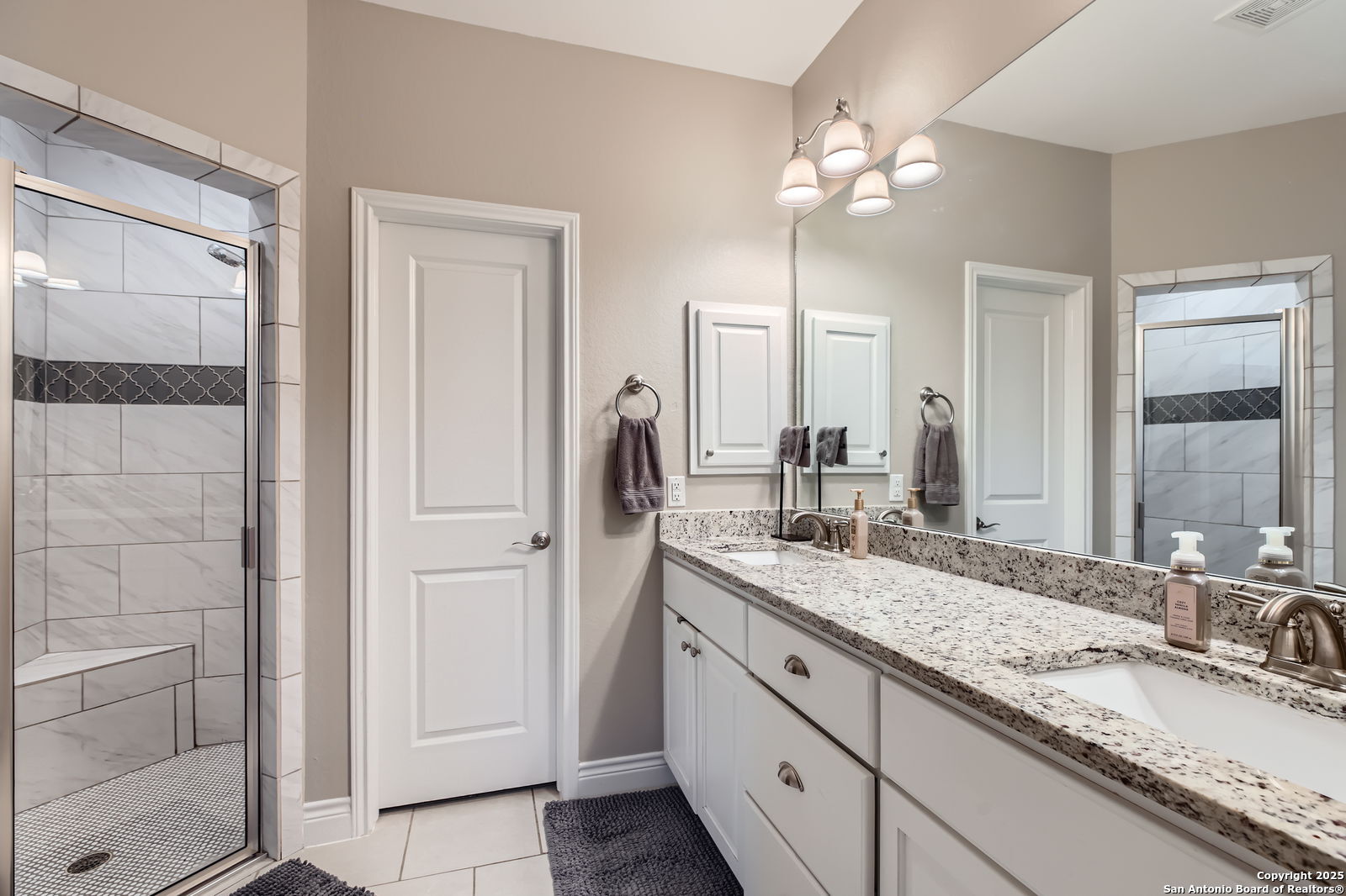 1041 Madrone Road Fischer, TX 78623 - Photo 19 of 29 a bathroom with a granite countertop double vanity sink a mirror and shower