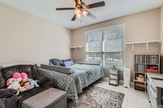 a bedroom with furniture and a window