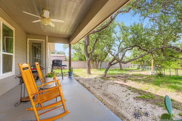 a view of a backyard with table and chairs