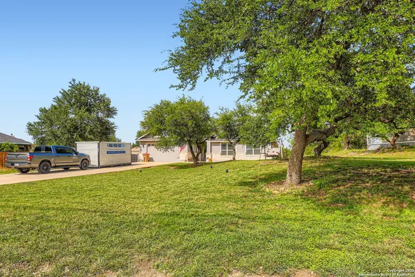 a view of a yard with a house in the background