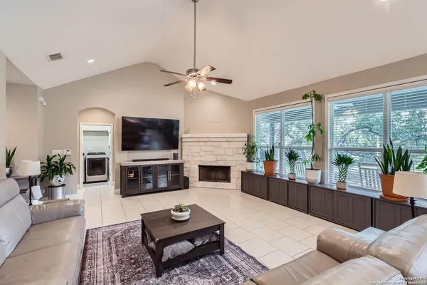 a living room with furniture fireplace and a flat screen tv