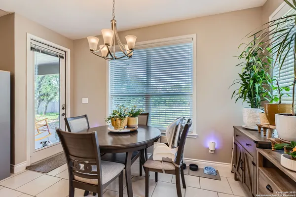 a view of a dining room with furniture and chandelier