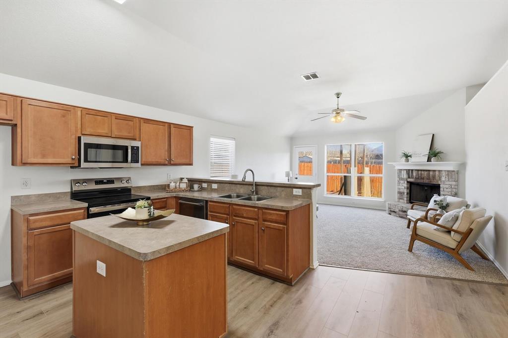 121 Kings Way Drive Rhome, TX 76078 - Photo 13 of 38 a kitchen with a sink stove and microwave