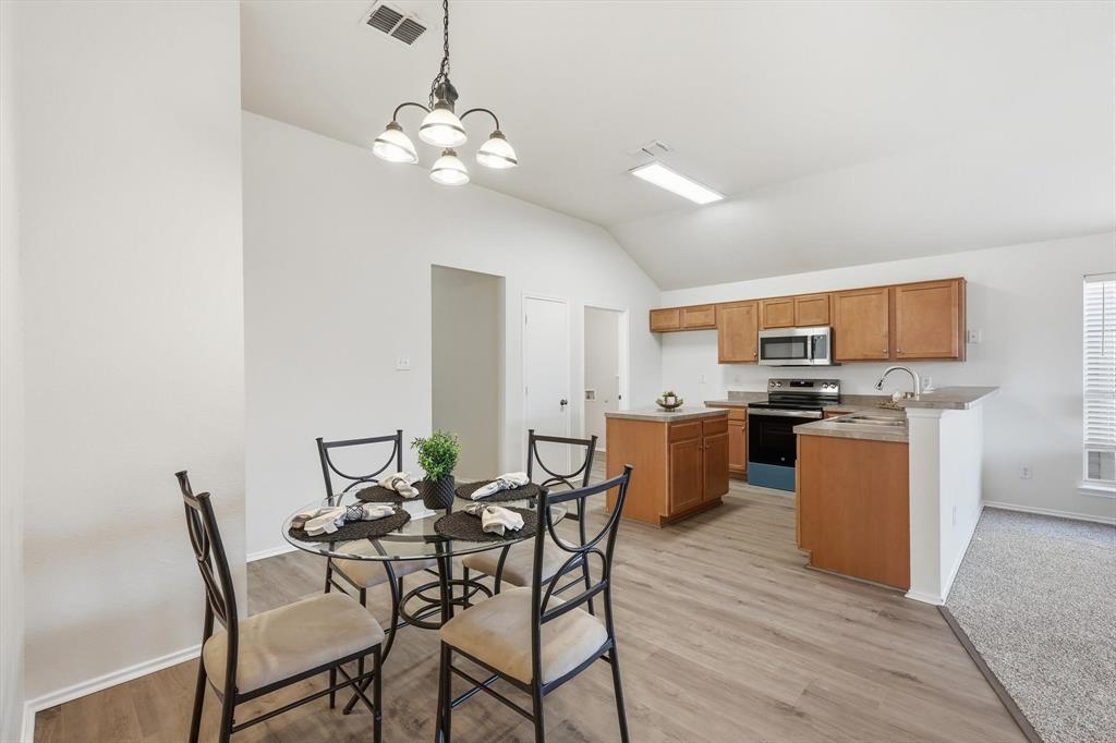 121 Kings Way Drive Rhome, TX 76078 - Photo 16 of 38 a view of a dining room with furniture and wooden floor