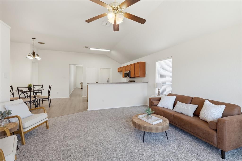 121 Kings Way Drive Rhome, TX 76078 - Photo 18 of 38 a living room with furniture and a dining table with chandelier