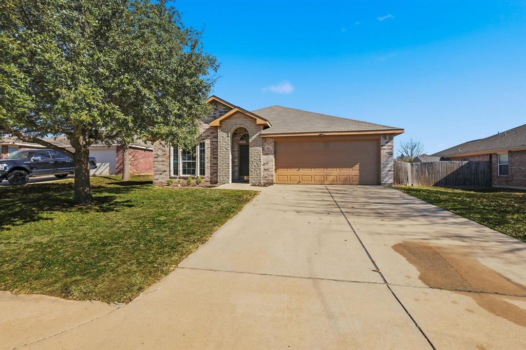 121 Kings Way Drive Rhome, TX 76078 - Photo 2 of 38 a front view of a house with a yard