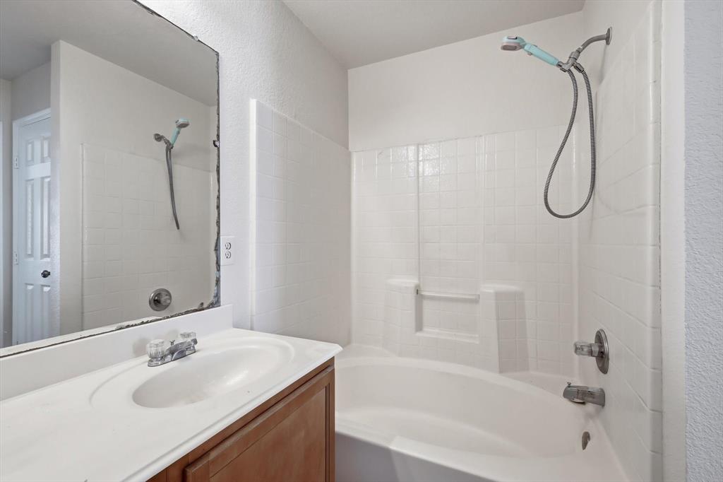 121 Kings Way Drive Rhome, TX 76078 - Photo 26 of 38 a bathroom with a sink vanity mirror and a bathtub