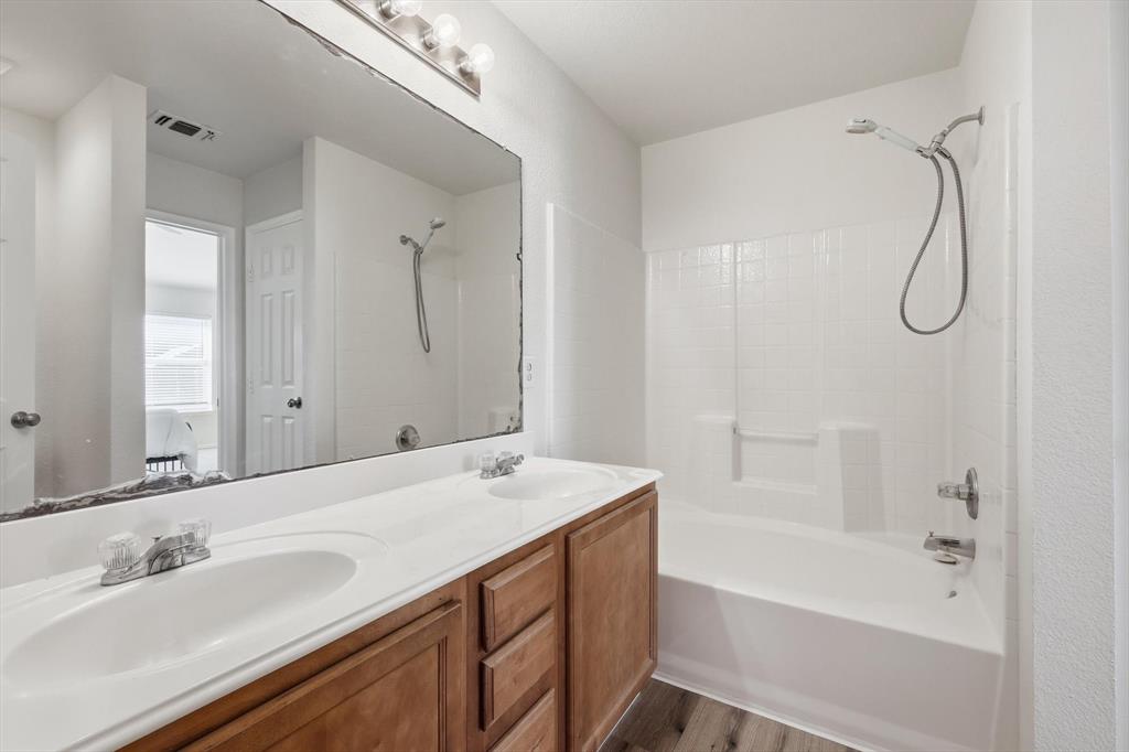 121 Kings Way Drive Rhome, TX 76078 - Photo 27 of 38 a bathroom with a tub sink and mirror
