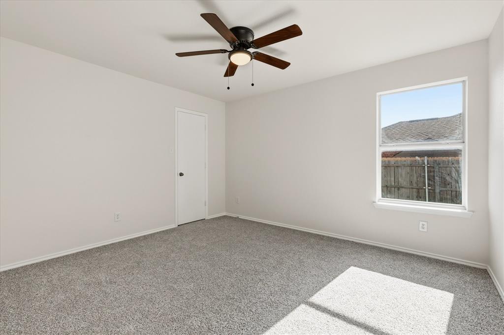 121 Kings Way Drive Rhome, TX 76078 - Photo 29 of 38 an empty room with ceiling fan and window