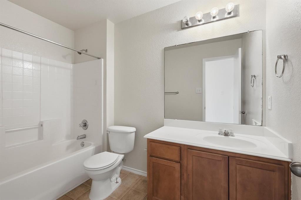 121 Kings Way Drive Rhome, TX 76078 - Photo 31 of 38 a bathroom with a sink toilet vanity and shower