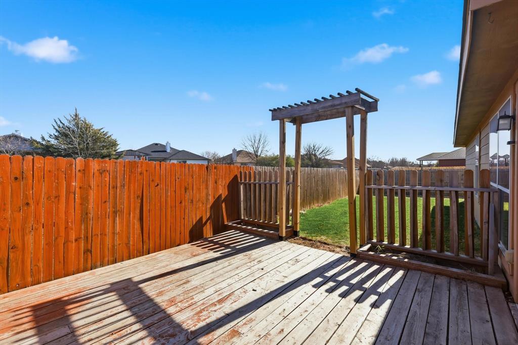 121 Kings Way Drive Rhome, TX 76078 - Photo 35 of 38 a view of a roof deck with wooden fence and floor