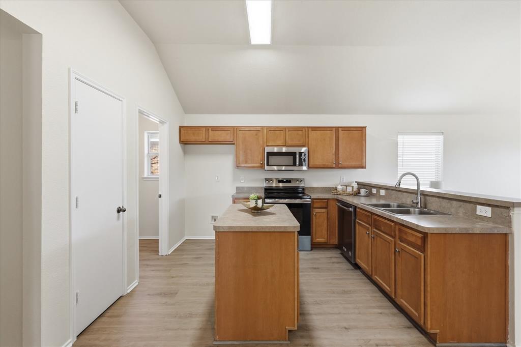121 Kings Way Drive Rhome, TX 76078 - Photo 10 of 38 a kitchen with stainless steel appliances granite countertop a sink stove and refrigerator
