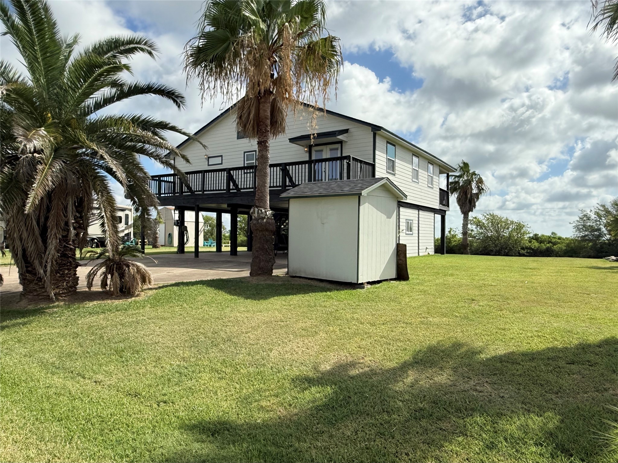 163 County Road 299 Sargent, TX 77414 - Photo 11 of 38 a yellow house sitting in middle of a field