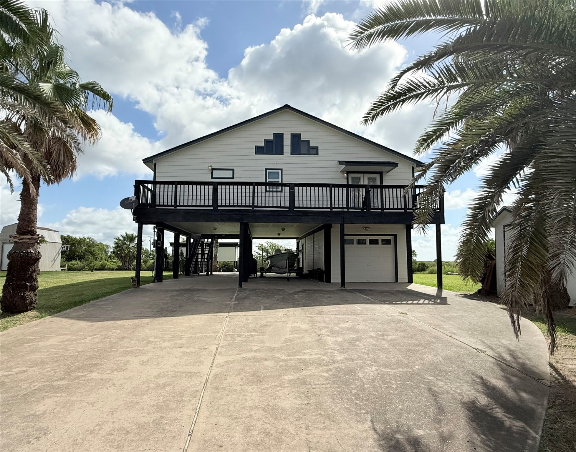 163 County Road 299 Sargent, TX 77414 - Photo 12 of 38 a view of a house with a yard and garage