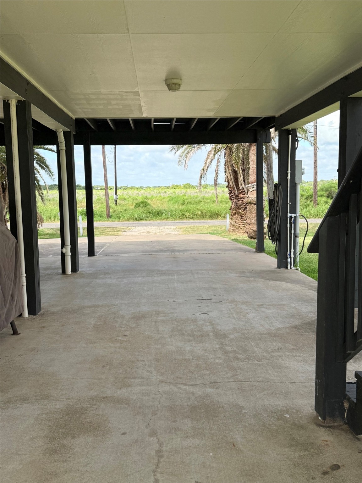 163 County Road 299 Sargent, TX 77414 - Photo 16 of 38 a view of an empty room with a floor to ceiling window and a yard
