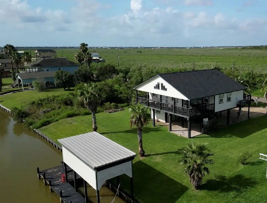 163 County Road 299 Sargent, TX 77414 - Photo 2 of 38 an aerial view of a house with swimming pool garden and lake view