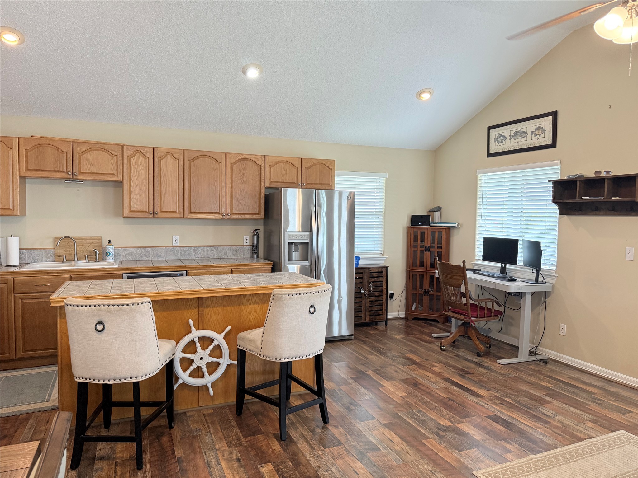 163 County Road 299 Sargent, TX 77414 - Photo 25 of 38 a kitchen with a table chairs refrigerator and wooden cabinets