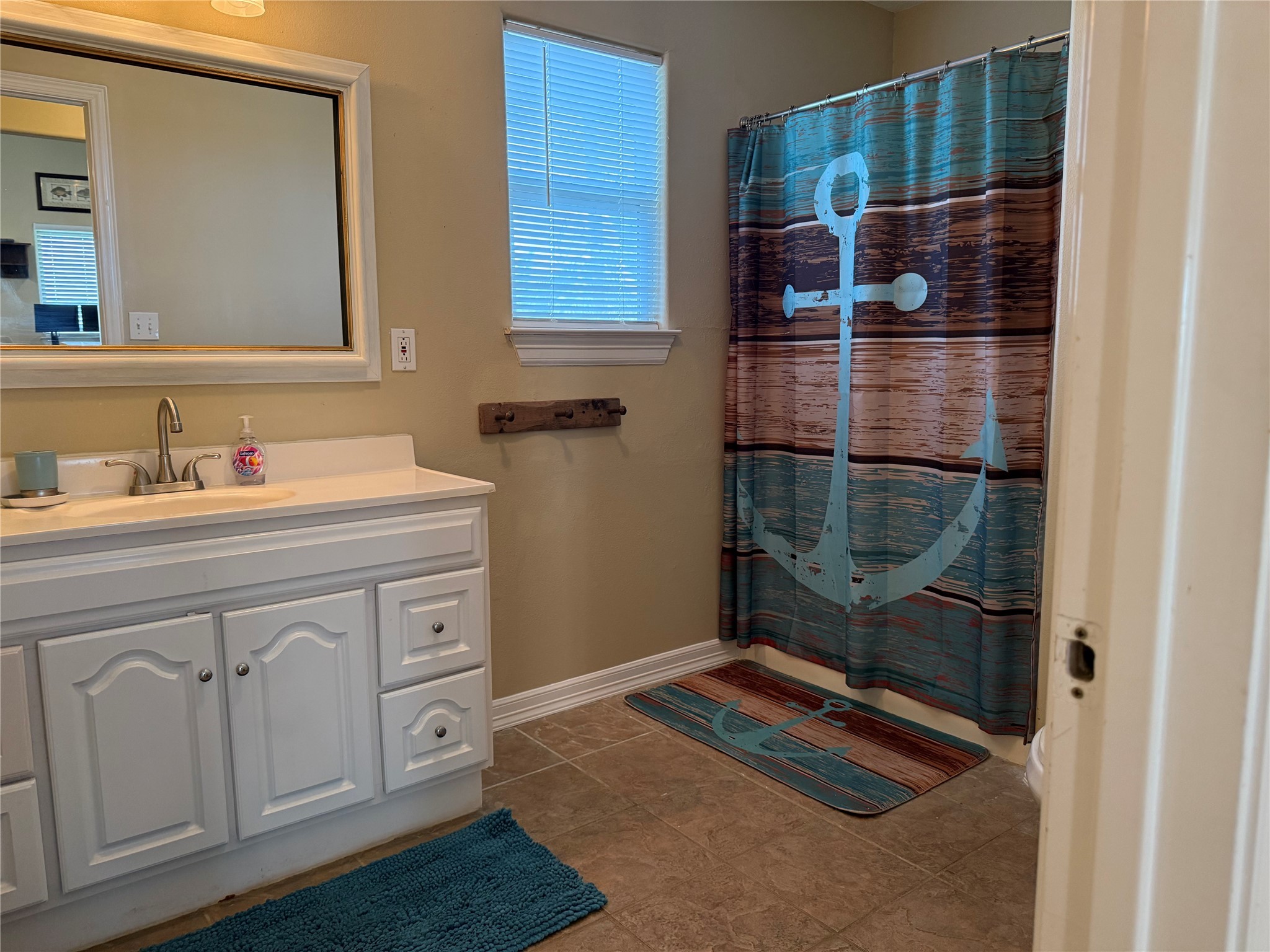 163 County Road 299 Sargent, TX 77414 - Photo 31 of 38 a bathroom with a sink and a mirror
