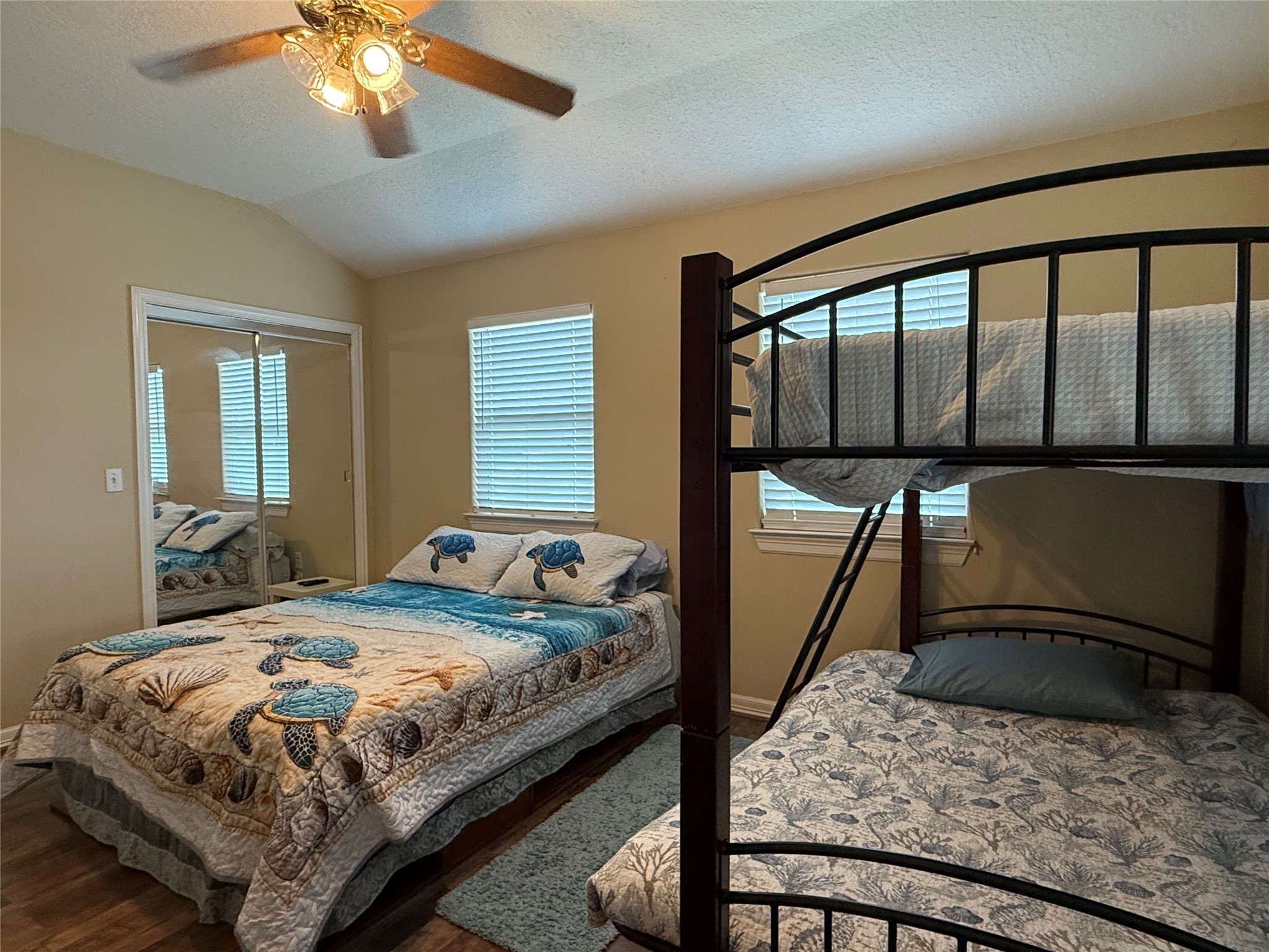 163 County Road 299 Sargent, TX 77414 - Photo 32 of 38 a bedroom with a large bed and a chandelier