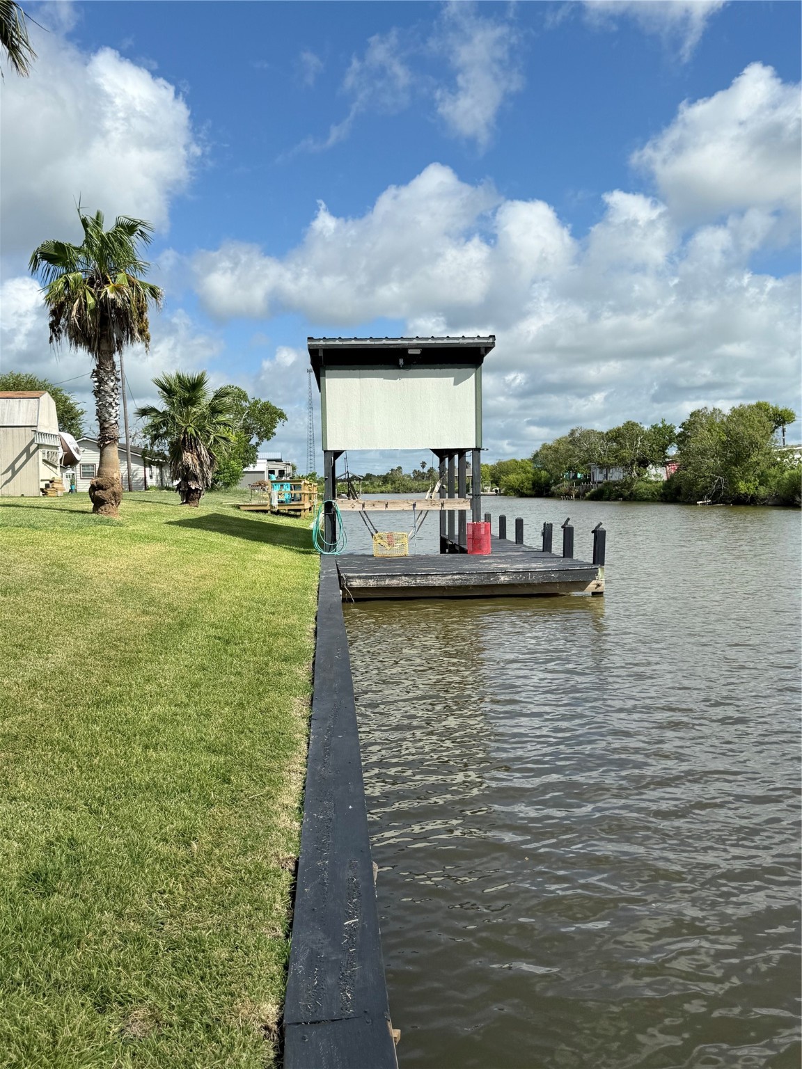 163 County Road 299 Sargent, TX 77414 - Photo 5 of 38 a view of a lake with house in background