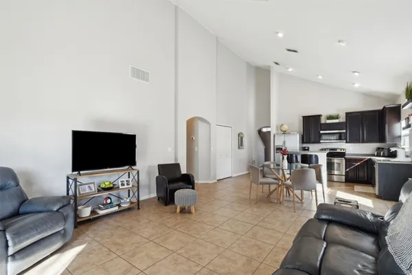 a kitchen with stainless steel appliances kitchen island granite countertop a refrigerator and a stove top oven