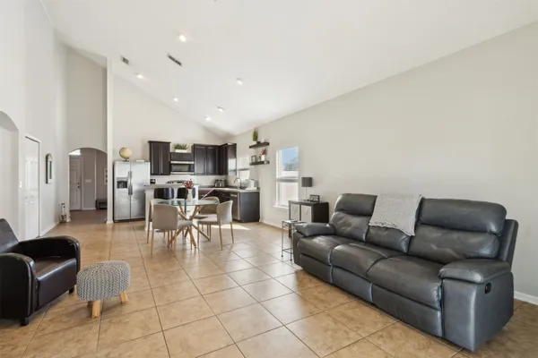 a kitchen with stainless steel appliances granite countertop a refrigerator and a sink