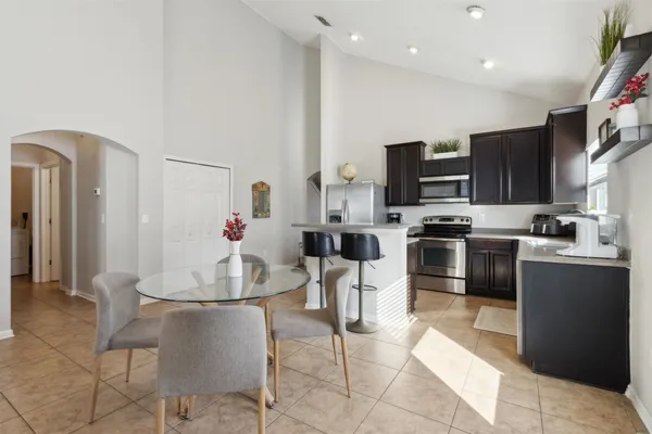 a kitchen with stainless steel appliances a sink stove and cabinets