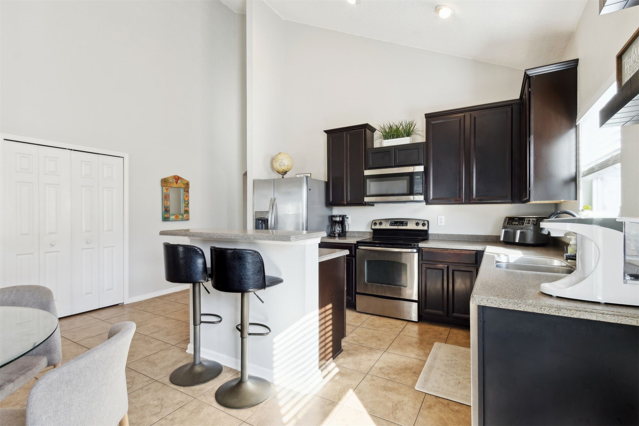 95029 Lavender Lane Fernandina Beach, FL 32034 - Photo 24 of 64 a kitchen with stainless steel appliances granite countertop a stove top oven a sink a dining table and chairs with wooden floor