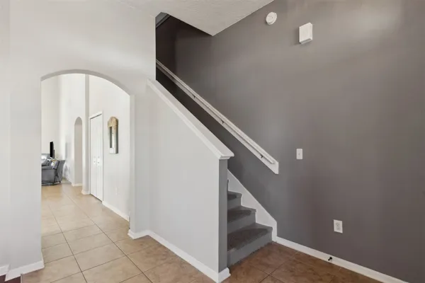 a bedroom with a bed table closet and a window