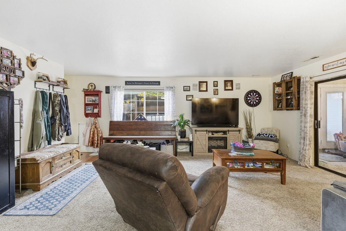 650 Sarah Lane Eagle Point, OR 97524 - Photo 6 of 19 a living room with furniture and a flat screen tv