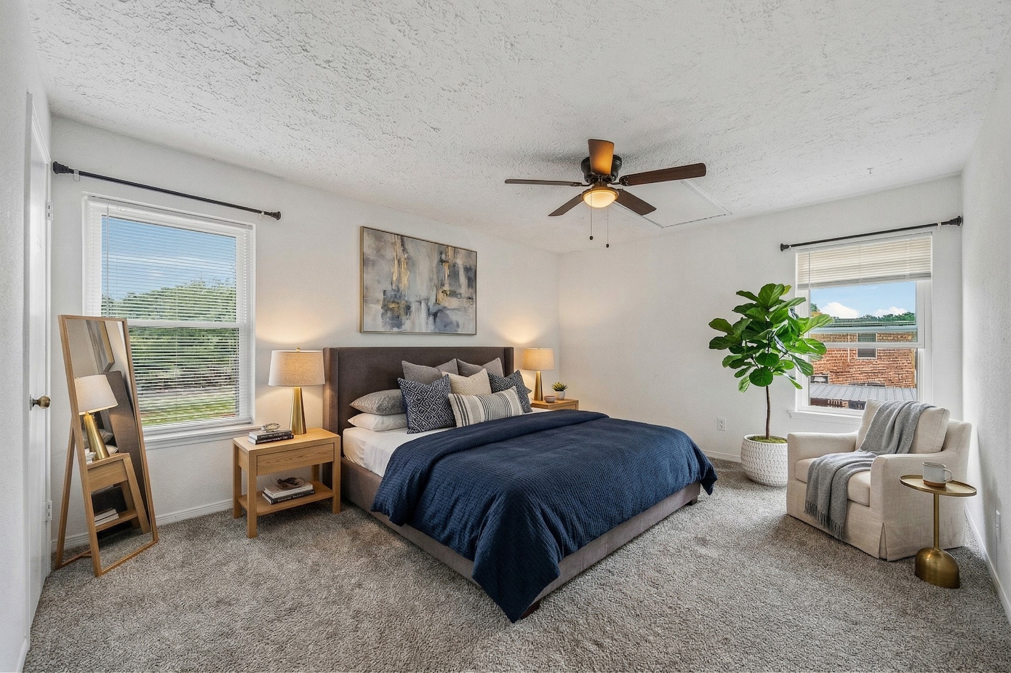 830 Threadneedle Street, Unit 240 Houston, TX 77079 - Photo 18 of 33 This spacious, well-lit bedroom features neutral carpeting, two large windows with views, and a ceiling fan for comfort.