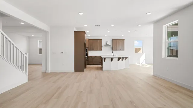 a view of a kitchen with wooden floor and windows