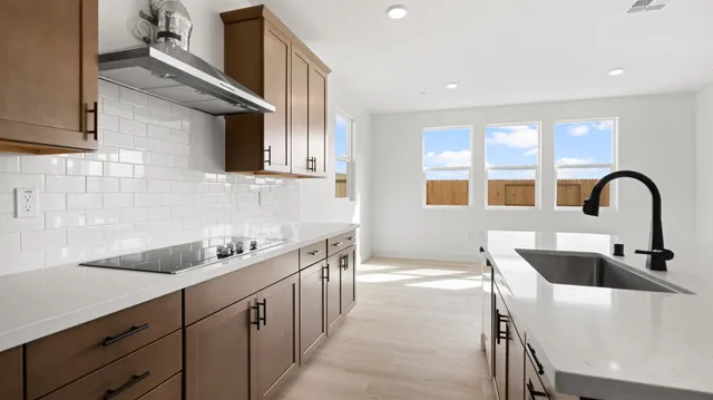 a view of a kitchen with a sink stainless steel appliances and cabinets